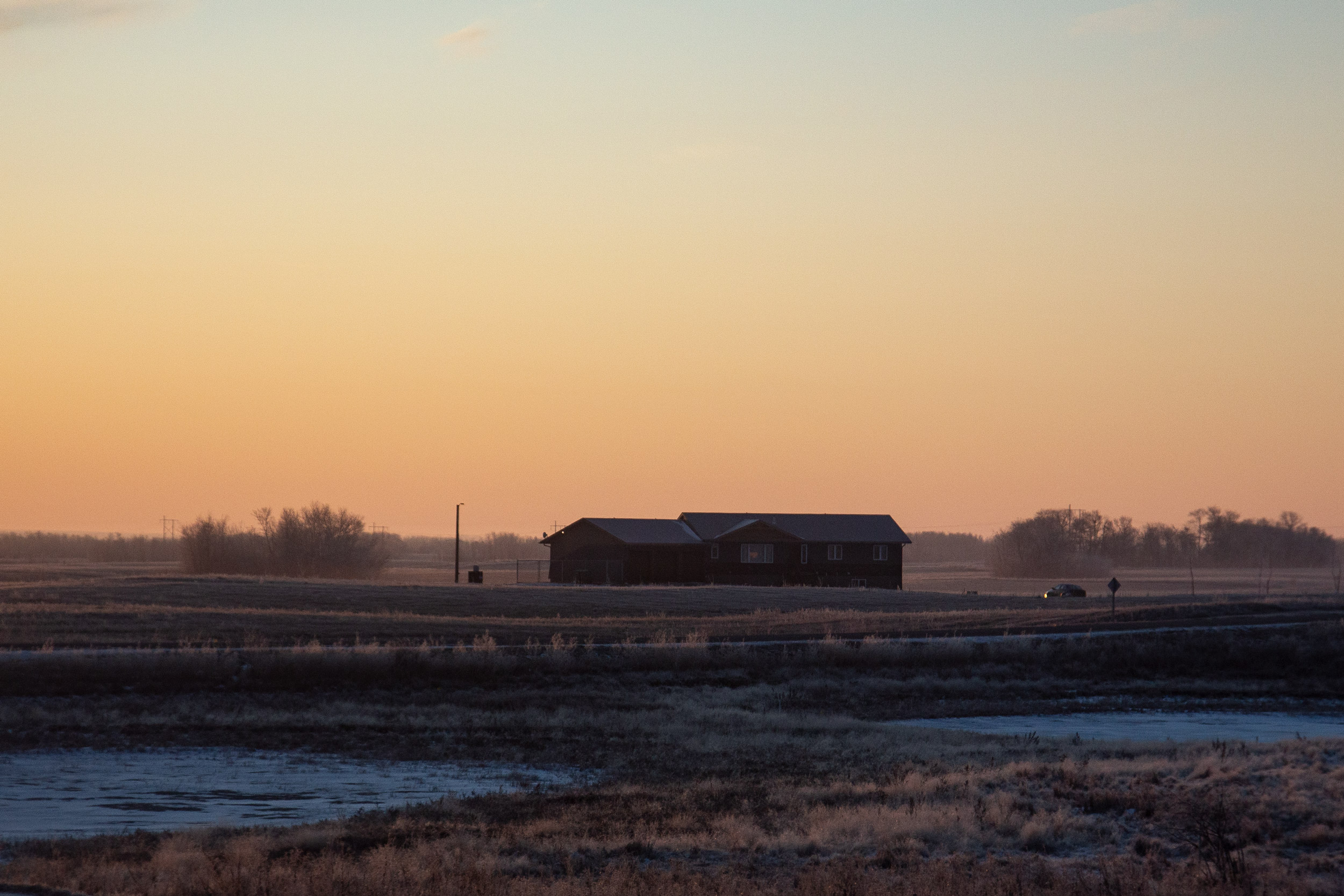 Photo of a farm in Canada during sunset.